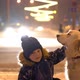 Love for Pets. Little Boy Stroking His Dog Outdoors in Winter in the Evening City - VideoHive Item for Sale