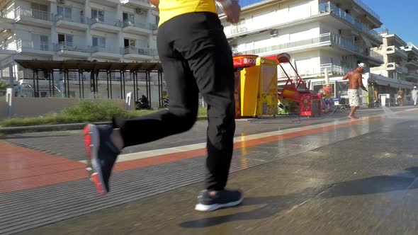 Man Jogging along the City Street alt