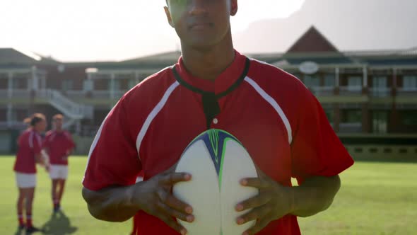 Male rugby player standing with rugby ball on the rugby ground 4k