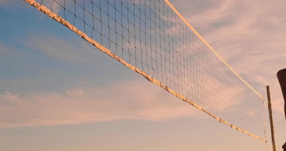 Beach Volleyball Match Girls Hit the Ball in Slow Motion at Sunset on the Sand. alt