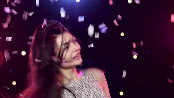 Carefree Girl Are Dancing Against Disco Lights and Glitter Confetti alt