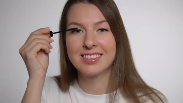 Young Beautiful Woman Doing Makeup
