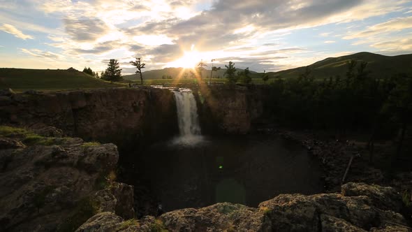 Sunset Over Waterfall Ulaan Tsutgalan, Mongolia.  Timelapse alt
