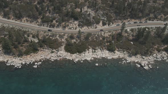 Aerial cinematic view mountain lake road. Road along mountains and lake. alt