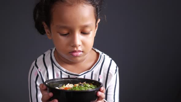 Child Girl Holding Fresh Vegetable Salad Bowl alt