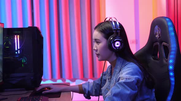 Young Asian Gamer Playing Video Game alt