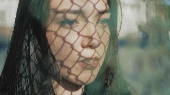 cool fashion serious teenage woman wearing in black, leather jacket, choker necklace with a long dar alt