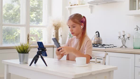 Teen Girl Having a Video Call Via Smartphone at Home in Kitchen