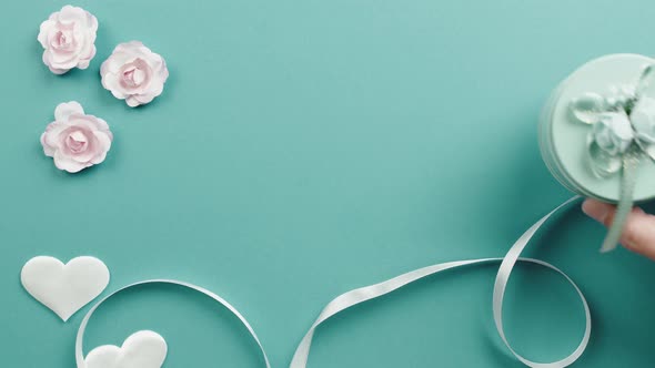 Blue Background with Flowers Heart and Gift with Copy Space alt