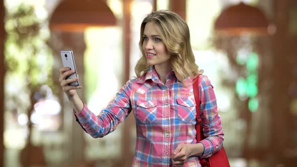 Attractive Girl in Casual Cloth Taking Selfie Using Her Smartphone alt