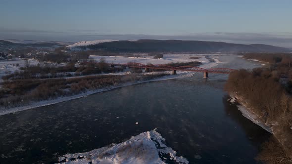 Early Morning Aerial View on the Frozen River Scenic Landscape at Sunny Winter Day  Drone Video