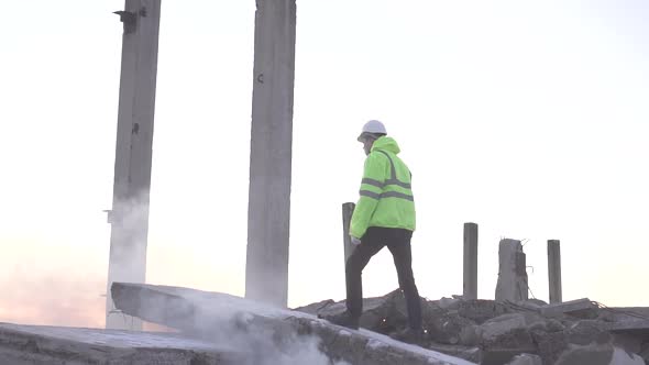 Rescuer in a Signal Vest After an Earthquake Is Looking for Victims in a Disaster alt
