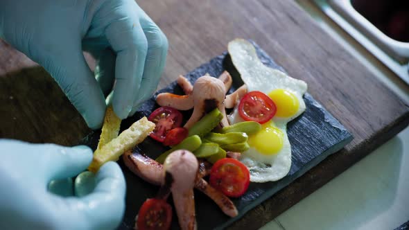 Proper Nutrition, Tasty Healthy Balanced Meal on Black Plate with Fried Eggs Sausages and Vegetables alt