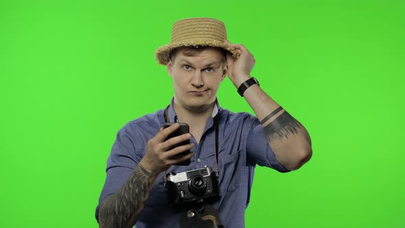 Portrait of Man Tourist Is Looking for Route on Map in a Smartphone. Chroma Key alt