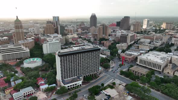 Cinematic wide aerial of San Antonio skyline and tourist attractions during sunset. Riverwalk area a alt