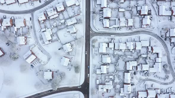 Aerial view of snow covered houses and roads in a residential area of the cit alt