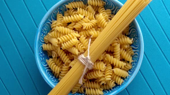 Fusilli Pasta and Spagetthi on Blue Background