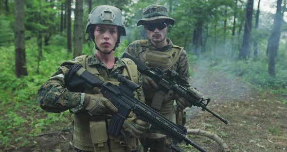 Squad of Soldiers Patrolling Across the Forest Area Team with Male and Female Soliders in Dense alt