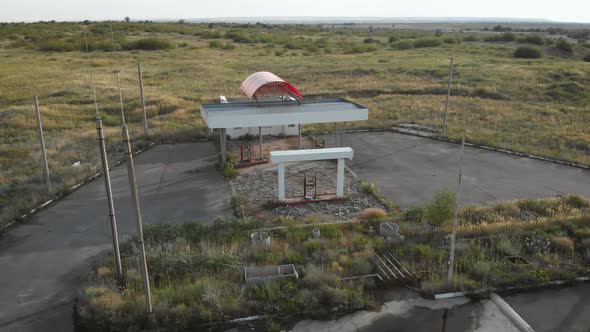Aerial View of Derelict Gas Station Next To the Road. Abandoned Petrol Station with No Fuel Signs alt