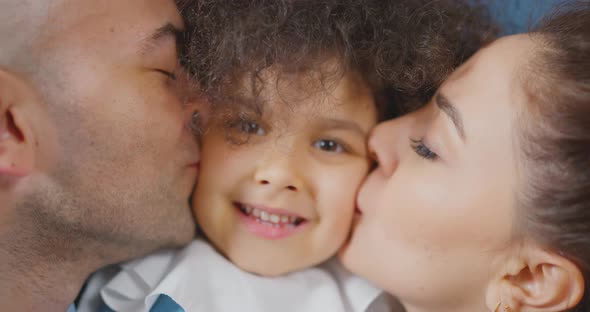 Happy family Dad and mom are kissing their daughter Turkish family alt
