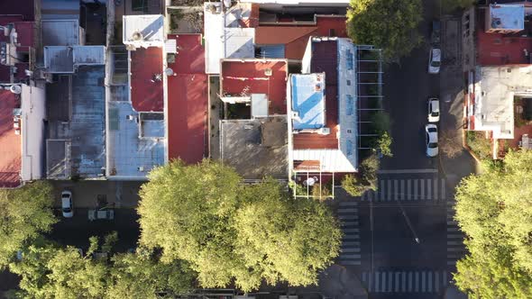 Drone: street houses terraces rooftops neighborhood. Bird`s eye view. Lateral dolly. alt