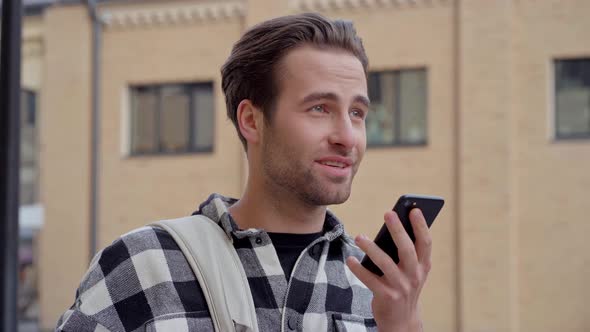 Man holding mobile phone and talking.