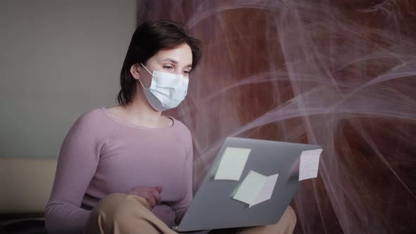 Woman at Home in Medical Mask Sit on the Bed in Front of Laptop Look at Pc Screen Chatting with alt
