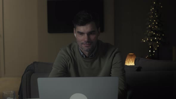 Adult man using laptop at home
