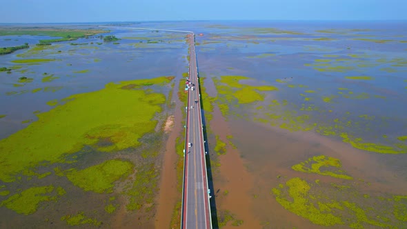 Drone video of the road leads through a large beautiful wetland. alt