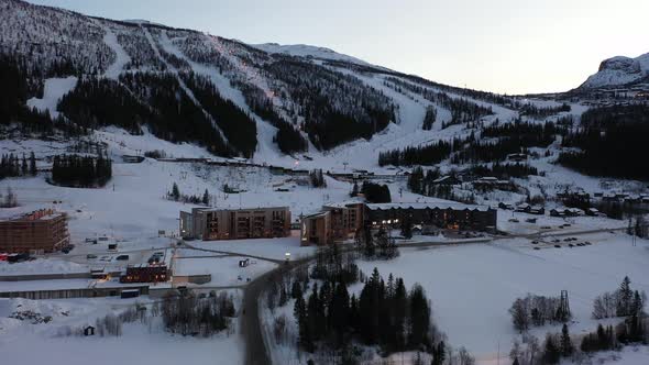 Famous skiing destination Hemsedal evening aerial - Distant overview with buildings in front and ski alt