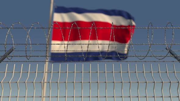Waving Flag of Costa Rica Behind Barbed Wire alt