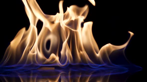 Falling Match Causes Flames to Ignite Against Black Studio Background alt