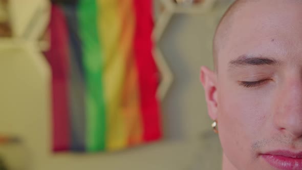 Indoor Closeup Shot of a Half of a Face of European Bald Gay Man with an Earring in His Ear Slowly alt