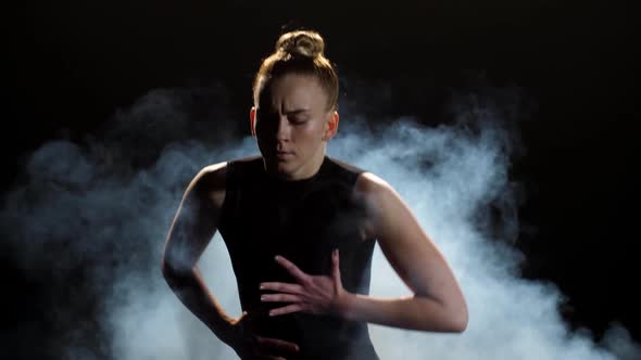 Expressive Young Woman Dancing in Clouds of Smoke alt