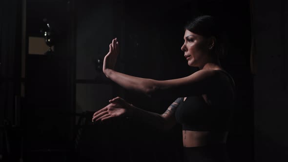 A Strong Tattooed Woman Showing Karate Fighting Hands Moves alt
