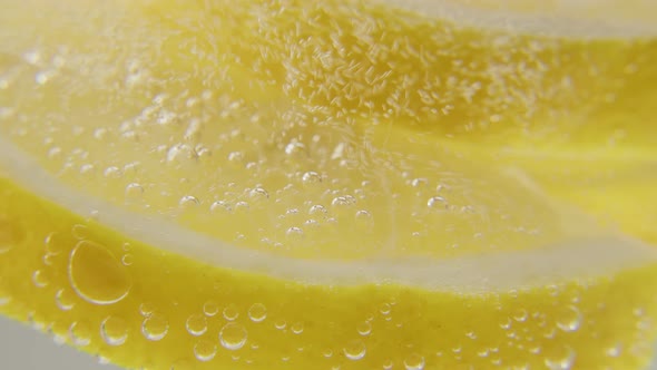 Fresh Lemon is Added to a Glass of Sparkling Ice Water Making a Refreshing Soft Drink alt