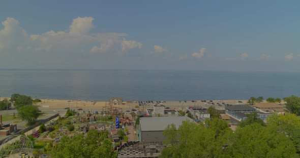 Backwards Aerial Pan Small Town Near Long Island Sandy Beach alt