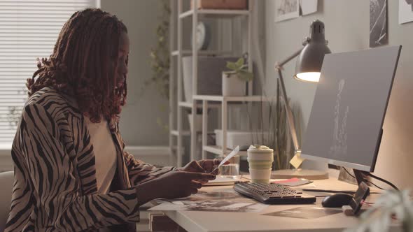 Female Photo Retoucher Working in Office alt