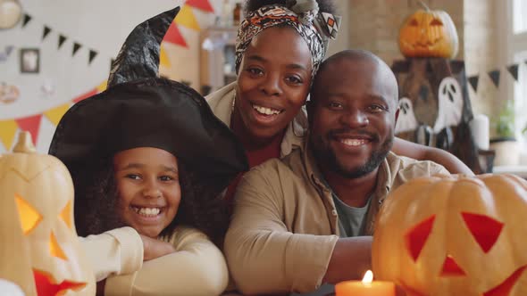 Joyous Afro-American Family Posing for Camera on Halloween alt