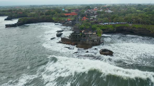Wide Panoramic View of Tanah Lot Temple in Dangerous Sea alt