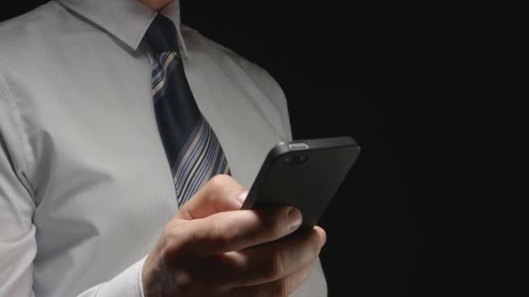 Businessman In White Shirt Holds A Smartphone By Hand And Touches On It alt