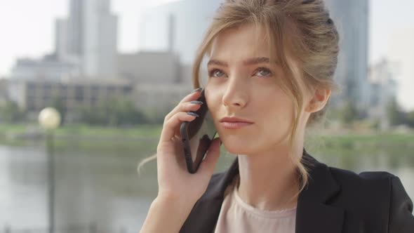 Closeup Of Businesswoman Talking On Phone Outdoors alt