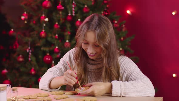 Young Smiling Woman Making Christmas Bakery Paints Festive Ginger Cookies