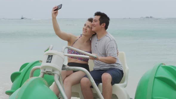 Couple taking selfie on water tricycle in Hawaii