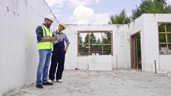 Male Engineers Discussing Work Details alt