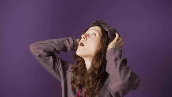 A Pile of Plastic Bottles is Being Thrown From Above on a Young Woman in Slow Motion Against a alt