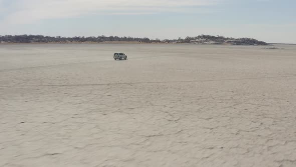 4x4 Car Driving On Dry Salt Pan Of Makgadikgadi Towards Kubu Island (Ga'nnyo) In Botswana, South Afr alt