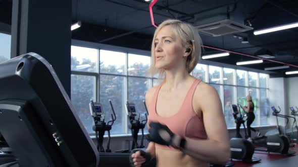 Young woman training on treadmill