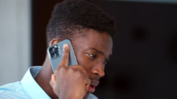 Portrait of young businessman having phone call alt