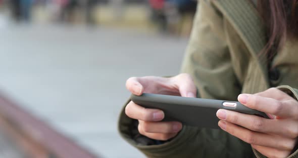Woman play game on smart phone alt